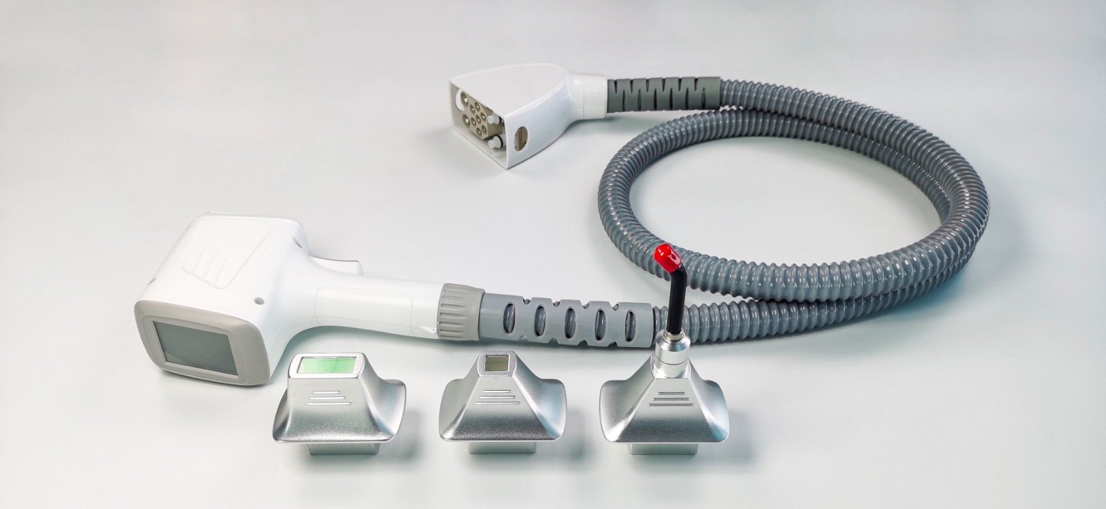 ADPL-2 diode laser handpiece with its three interchangeable treatment tips and connector cable