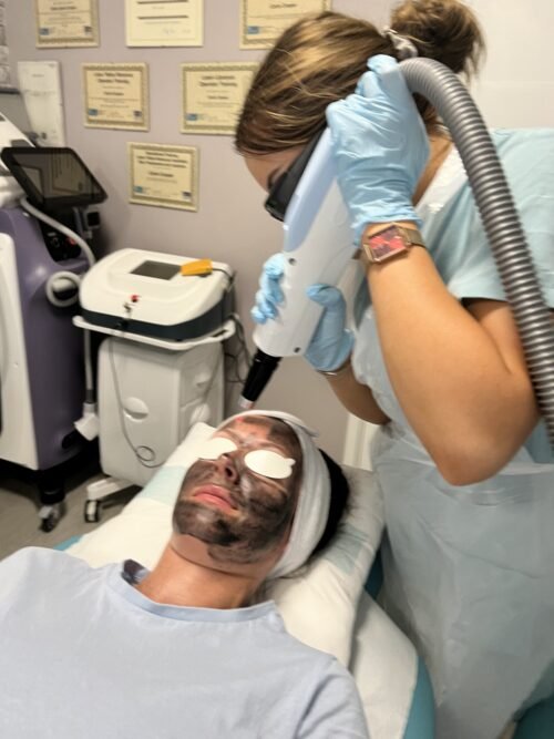 Two students carrying out supervised practical laser training at the Southampton academy