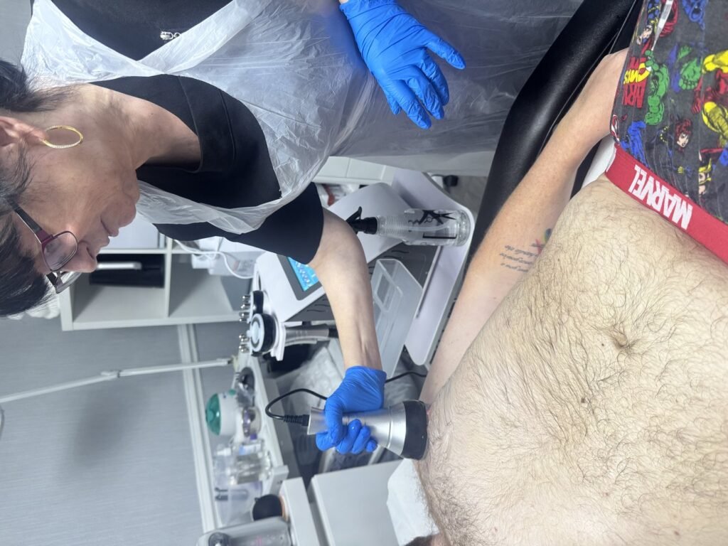 Carla Cooper-Gale measuring a student's arm during Level 4 ultrasound cavitation training
