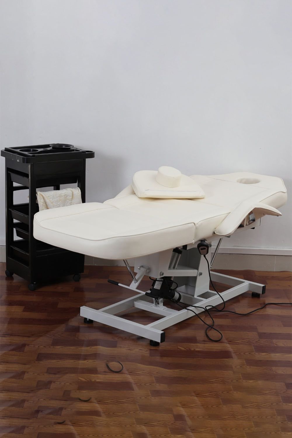 White electric facial bed with motorised height adjustment and reclining backrest