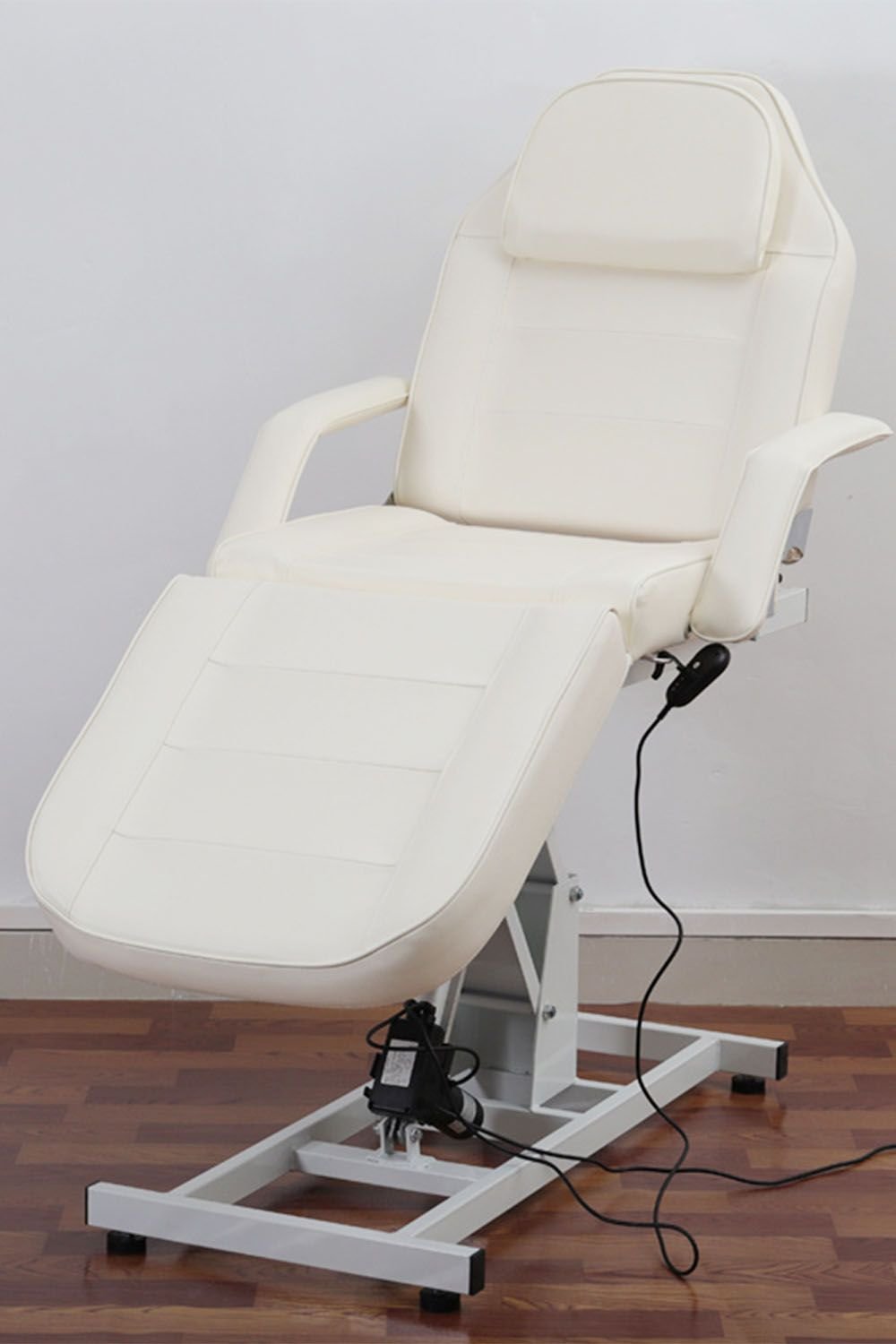 White electric facial bed with motorised height adjustment and reclining backrest